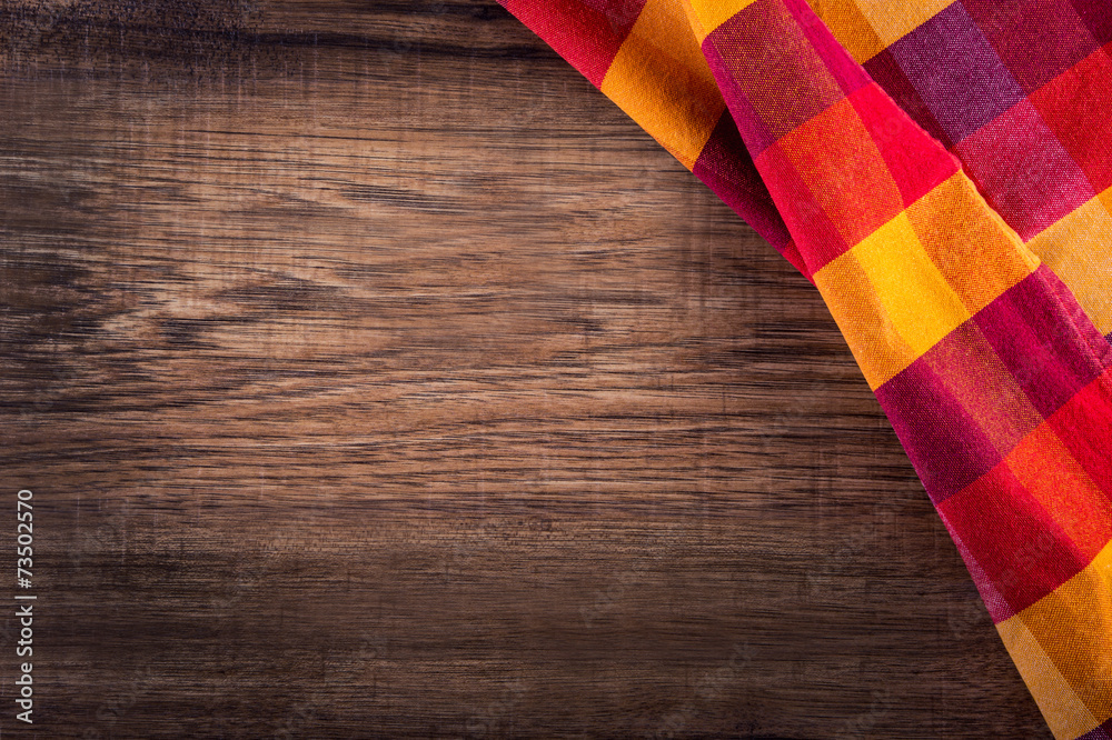 Top view of checkered napkin on empty wooden table Top view of checkered napkin on empty wooden table