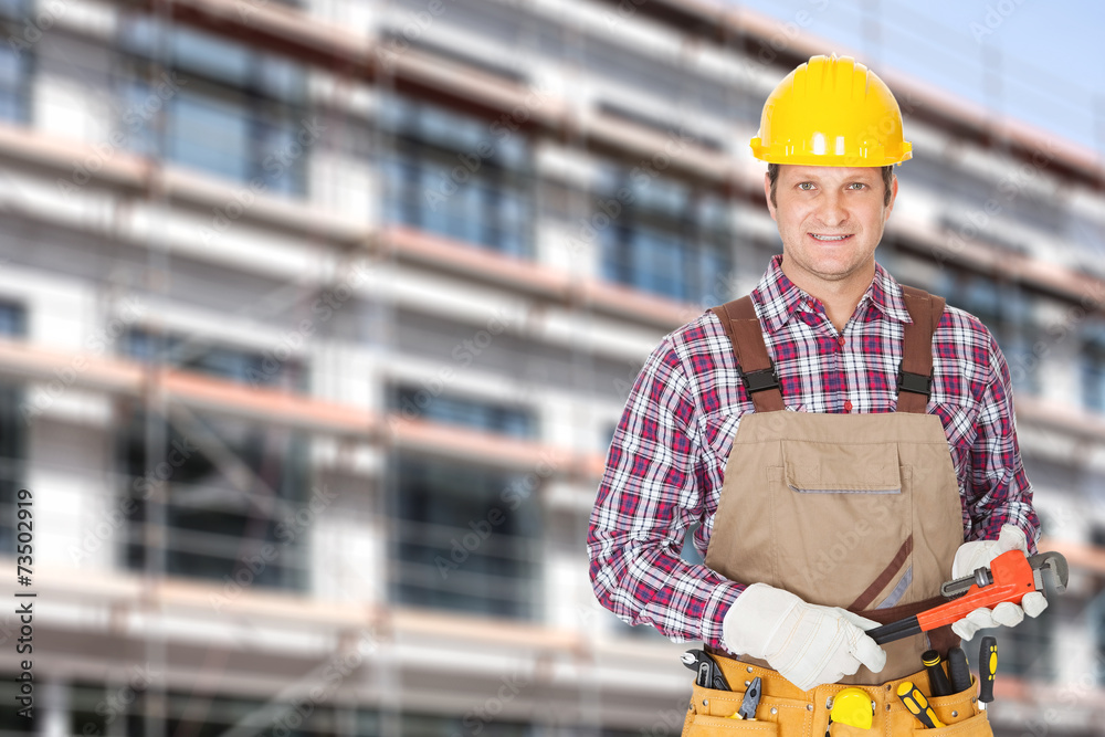 Architect Holding Adjustable Wrench Against Building Architect Holding Adjustable Wrench Against Building