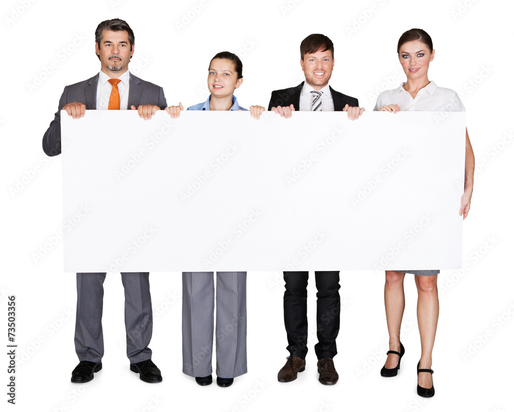 Confident Businesspeople Displaying Large Billboard Confident Businesspeople Displaying Large Billboard