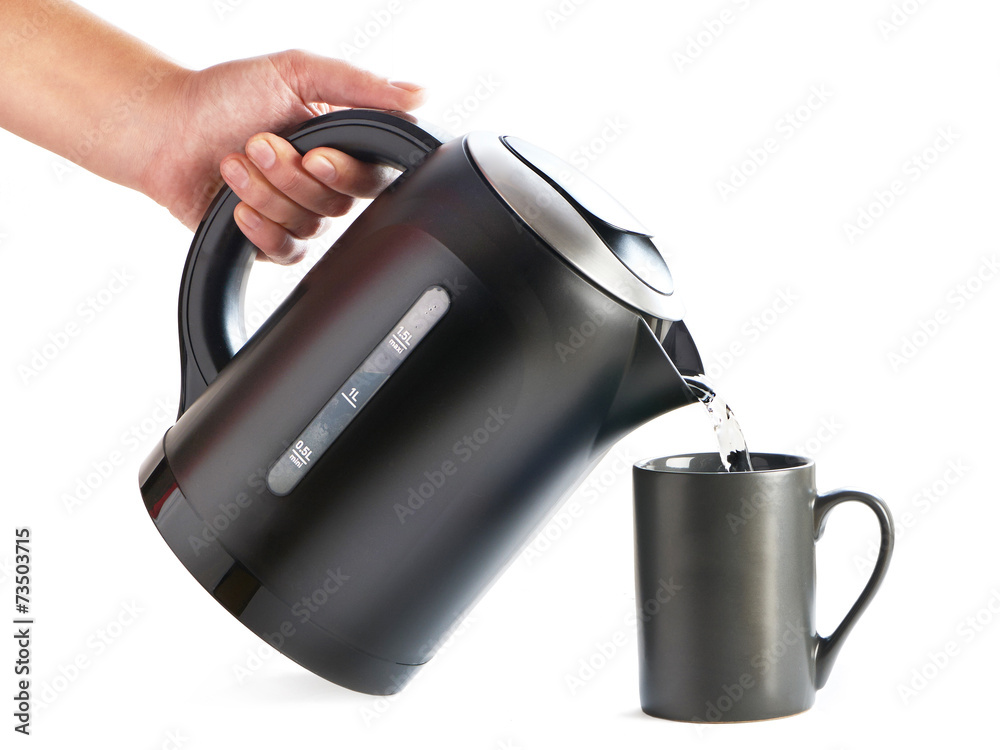 Modern kettle pouring water into cup isolated on white Modern kettle pouring water into cup isolated on white