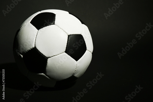 Soccer ball on black background © Africa Studio