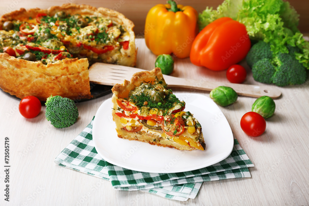 Piece of Vegetable pie with broccoli, peas, tomatoes and cheese