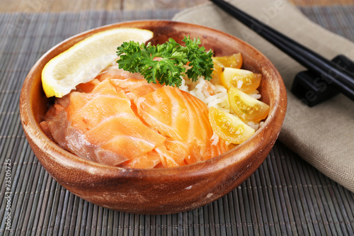 Bowl of boiled rice and fresh salted salmon