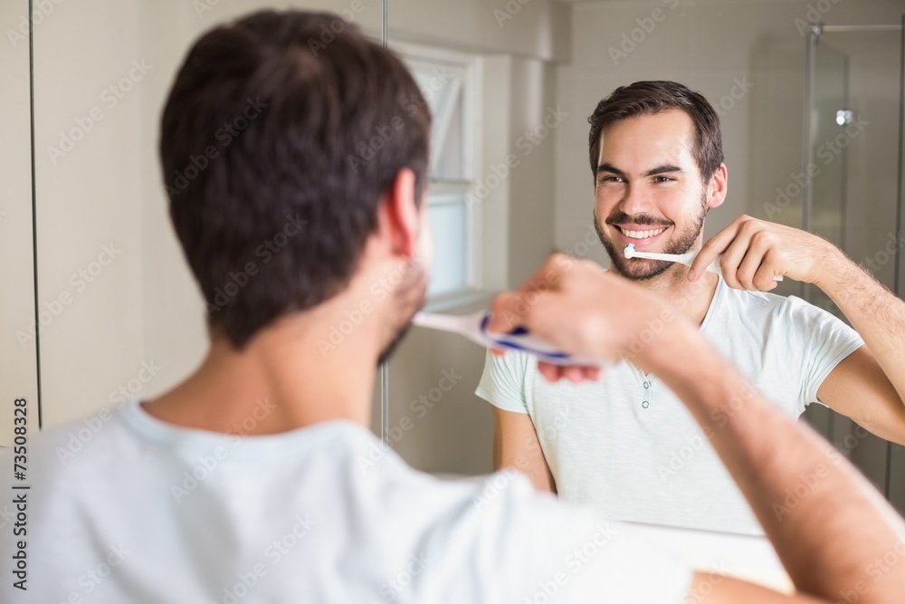 Fototapeta premium Young man brushing his teeth