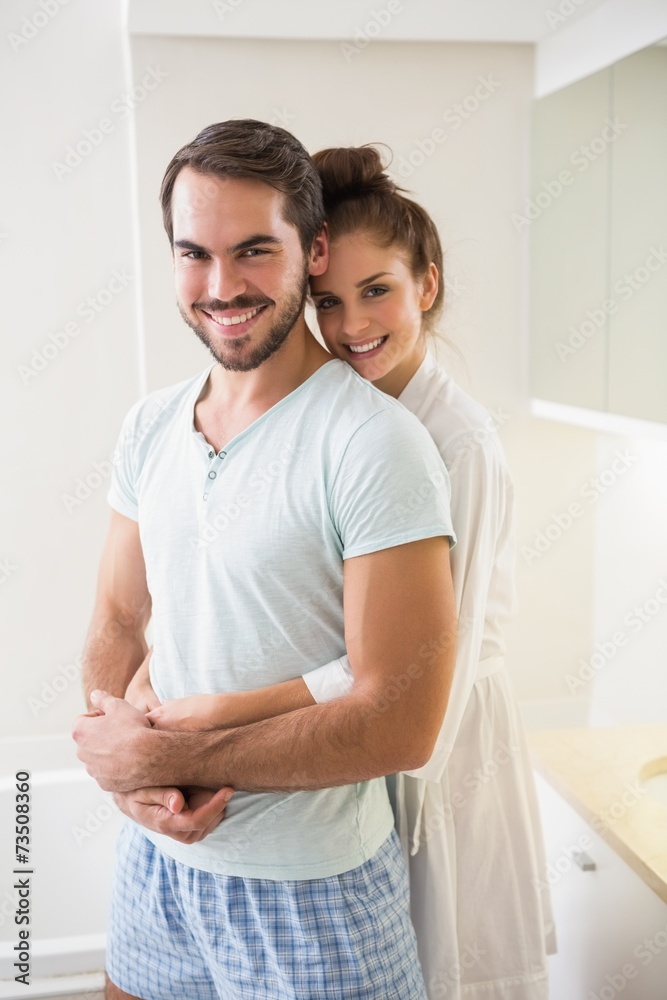 Young couple hugging and smiling at camera Young couple hugging and smiling at camera