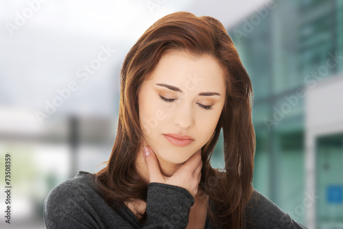 Young woman with terrible throat pain