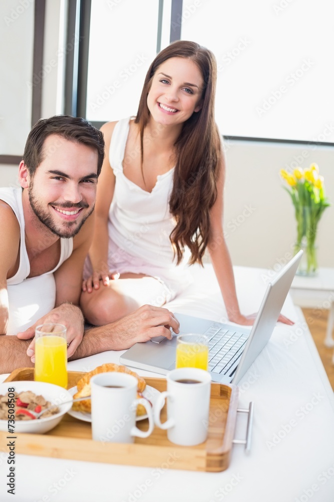 Young couple having breakfast in bed Young couple having breakfast in bed