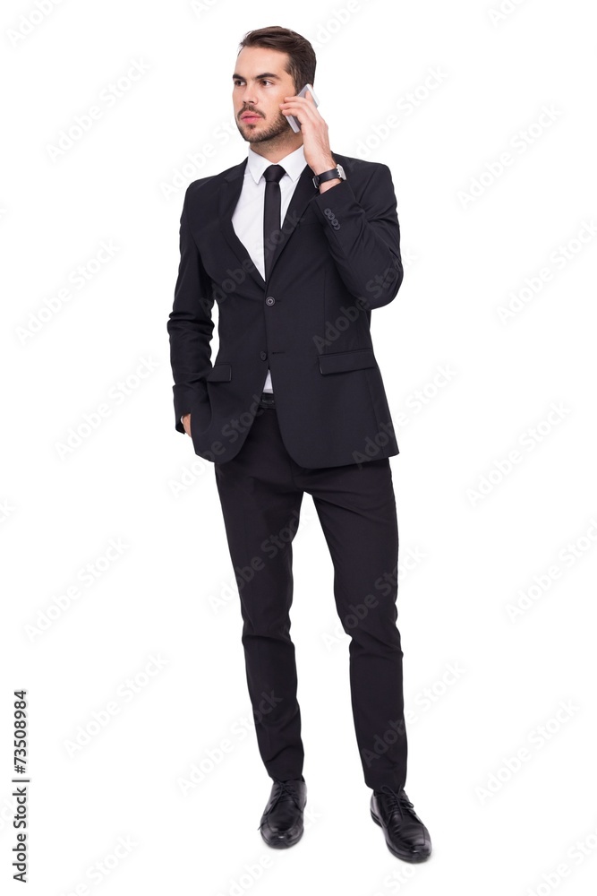Serious businessman hand in pocket phoning Serious businessman hand in pocket phoning