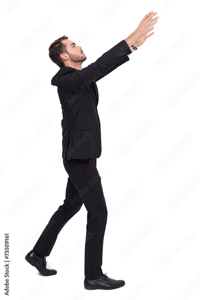 Businessman with arms raised catching something Businessman with arms raised catching something