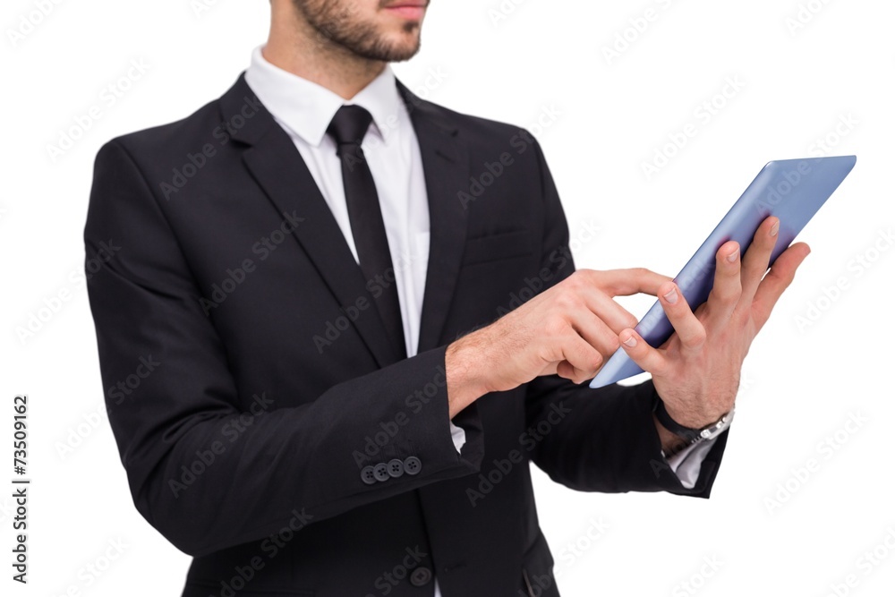 Mid section of a businessman using digital tablet pc Mid section of a businessman using digital tablet pc