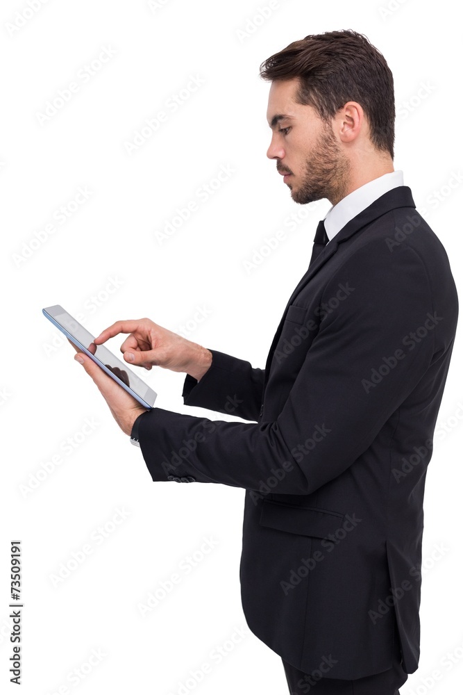 Concentrated businessman touching his tablet Concentrated businessman touching his tablet