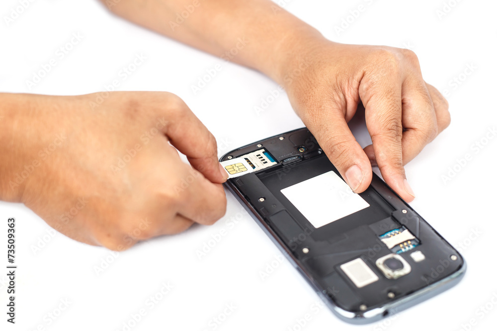 Hand holding sim card and put into smartphone isolated on white Hand holding sim card and put into smartphone isolated on white