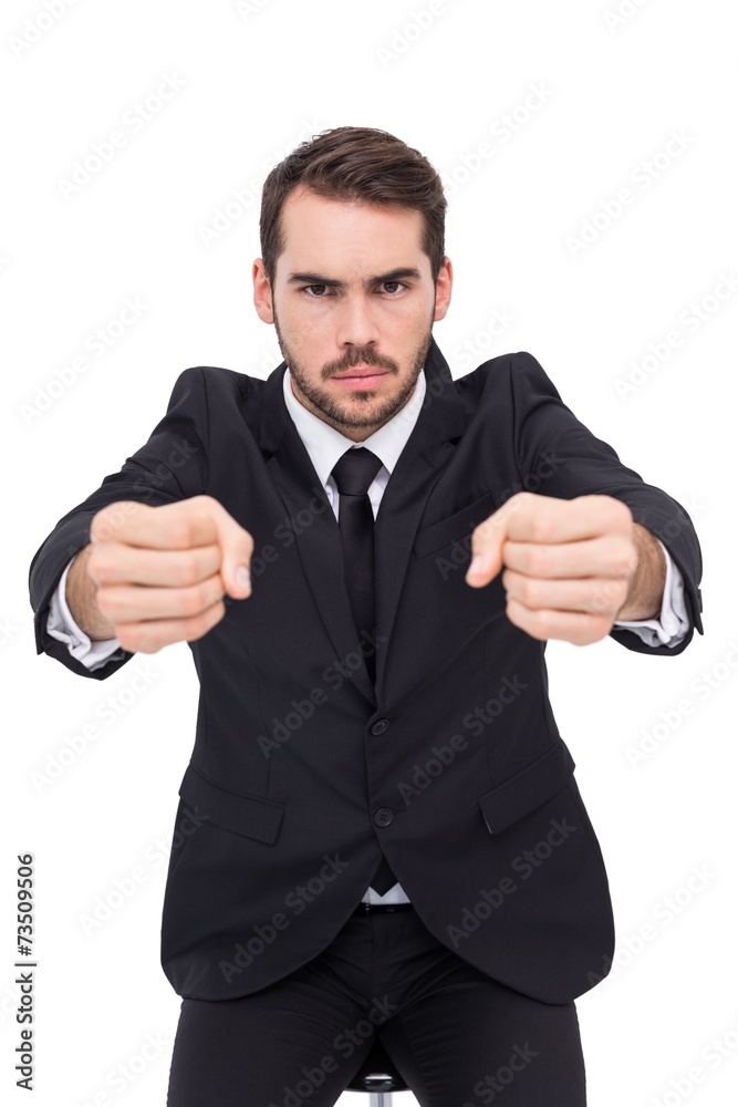 Angry businessman standing with clenched fists Angry businessman standing with clenched fists