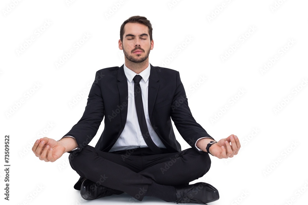 Peaceful businessman sitting in lotus pose relaxing Peaceful businessman sitting in lotus pose relaxing