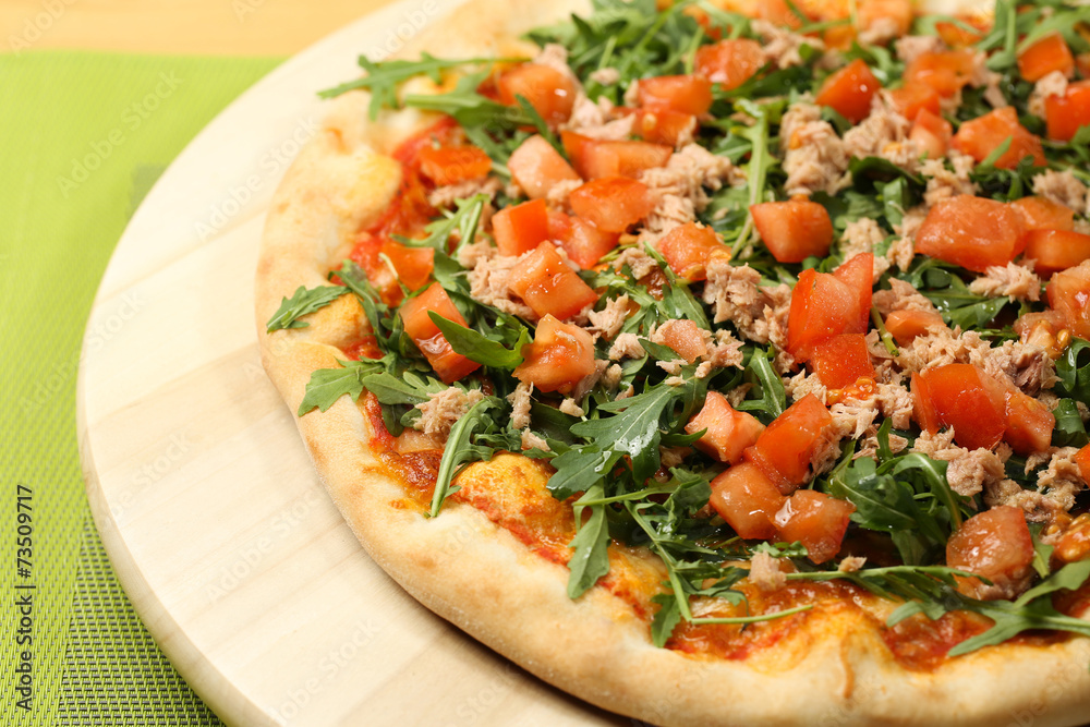 Delicious pizza on a wooden plate Delicious pizza on a wooden plate