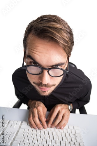 Portrait of a smiling businessman using computer