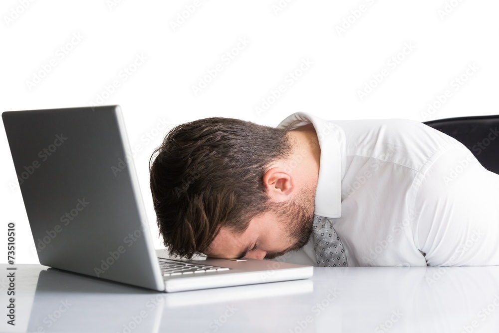 Exhausted businessman sleeping head on laptop Exhausted businessman sleeping head on laptop