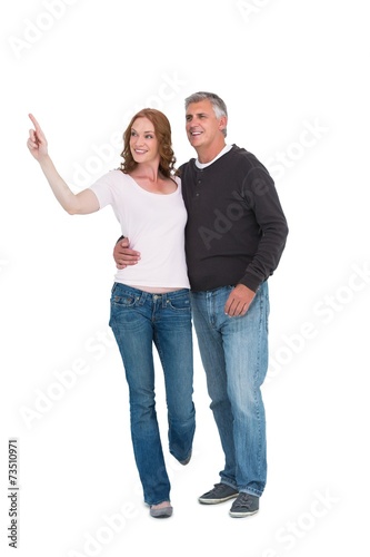 Casual couple walking and pointing