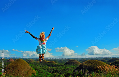 Young woman jumping on the chocolate hill