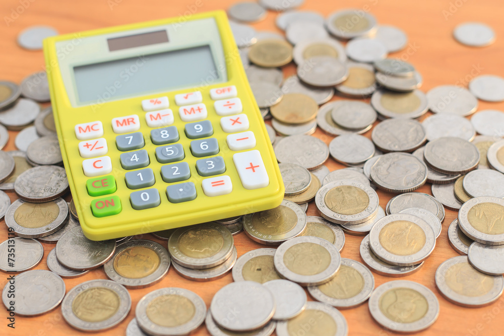 Close up calculator and coin on the table Close up calculator and coin on the table