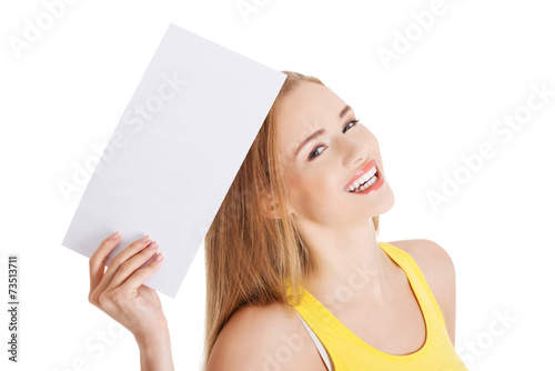 Happy woman holding white empty paper