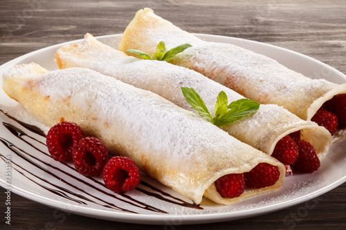 Pancakes with cream and raspberry