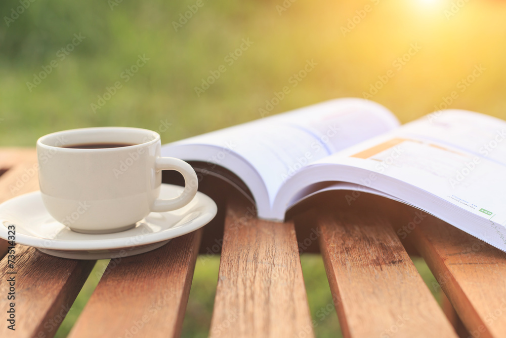 Close up Coffee cup and book on the table in the morning Close up Coffee cup and book on the table in the morning