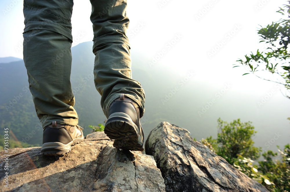 woman hiker stand on mountain peak rock 