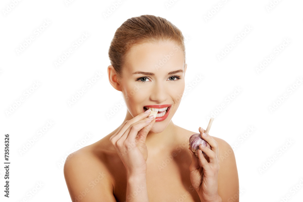Portrait of nude woman eating garlic Portrait of nude woman eating garlic