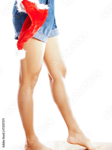 woman with santa hat wearing denim shorts