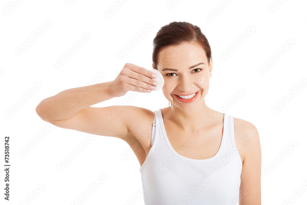 Young beautiful woman cleans the eye make-up Young beautiful woman cleans the eye make-up