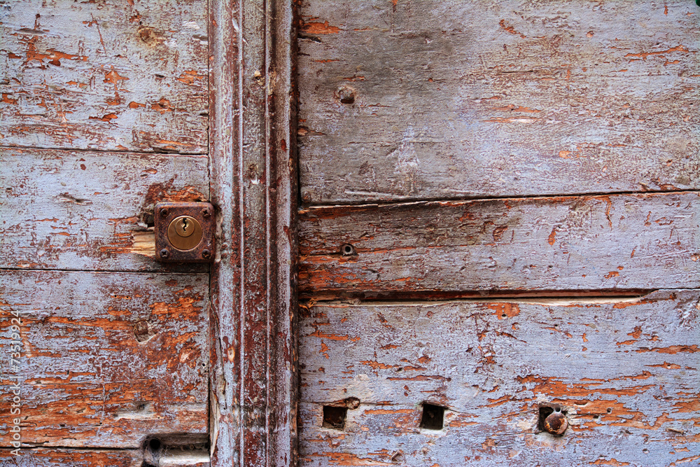 rusty keyhole in a wooden door rusty keyhole in a wooden door