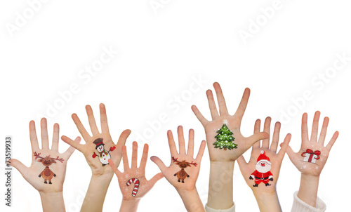 Childrens hands raising up with painted Christmas symbols