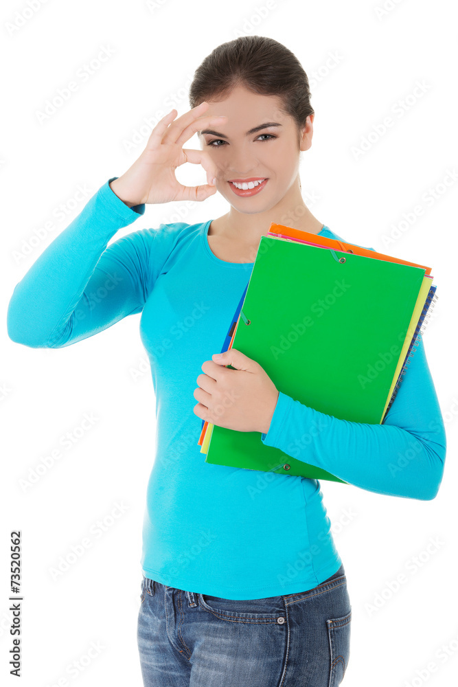 Young woman making ok sign holding notes Young woman making ok sign holding notes