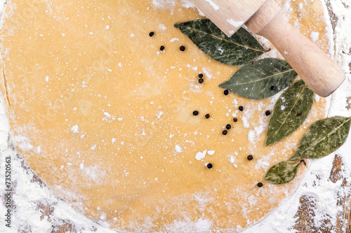 olling pin on a background of rolled dough on the table photo