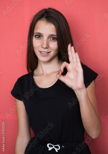 casual young woman showing the ok sign