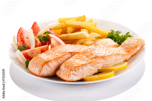 Grilled salmon and vegetables on white background
