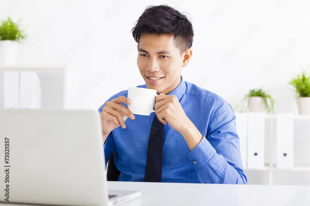 relaxed Young business man working in the office relaxed Young business man working in the office