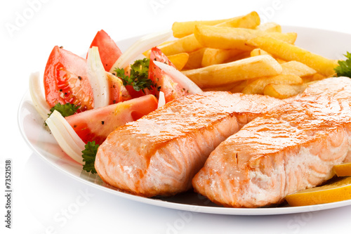 Grilled salmon and vegetables on white background