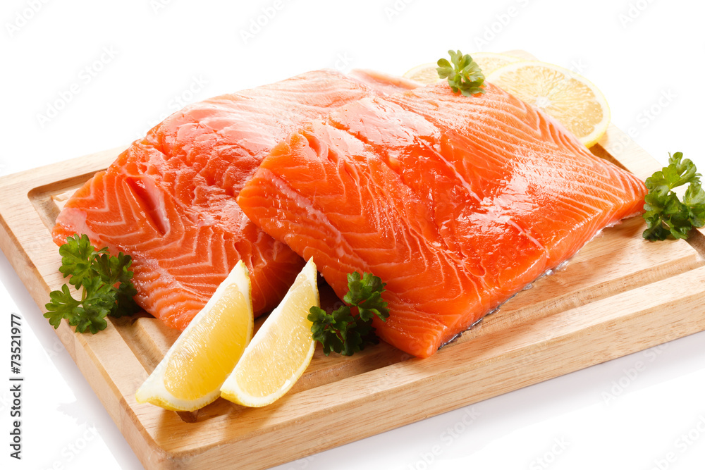 Fresh raw salmon fillet on cutting board Fresh raw salmon fillet on cutting board