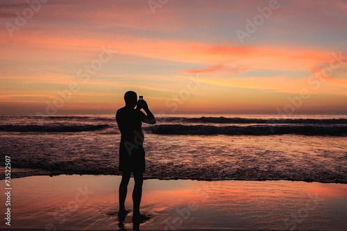 Silhouette of tourist at sunset beach in Phuket Thailand