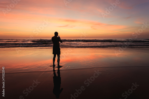 Silhouette of tourist at sunset beach in Phuket Thailand
