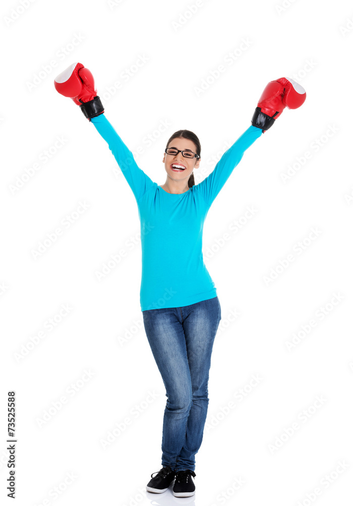 Attractive young woman wearing boxing gloves Attractive young woman wearing boxing gloves