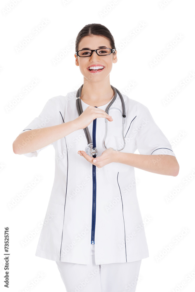 Happy female doctor holding something invisible Happy female doctor holding something invisible