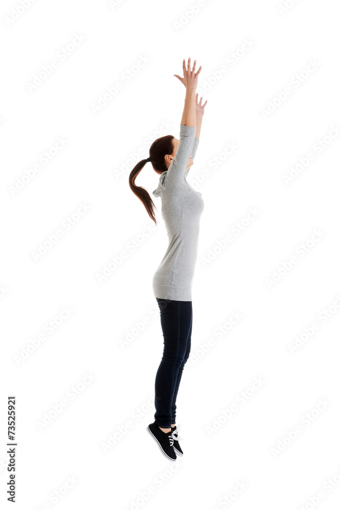 Side view woman trying to catch something high Side view woman trying to catch something high