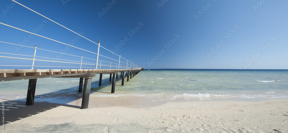 Wooden jetty on tropical beach