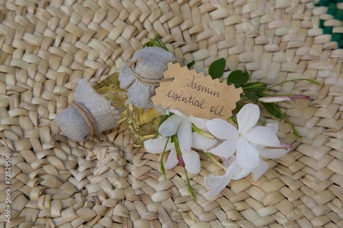 Jasmine essential oil on the woven surface photo