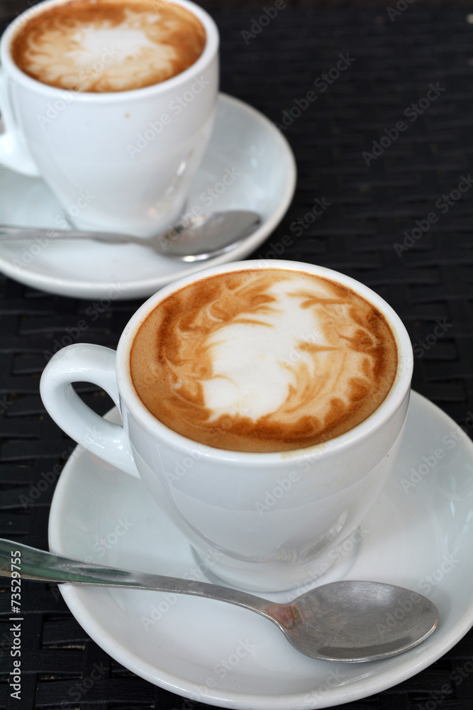 Cup of hot cappuccino on the black background Cup of hot cappuccino on the black background