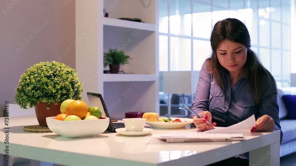 Woman eating healthy breakfast at home and smiling Woman eating healthy breakfast at home and smiling