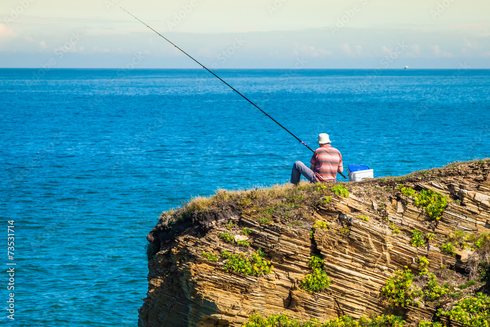 fisherman on the rocks,Ribadeo, Spain fisherman on the rocks,Ribadeo, Spain